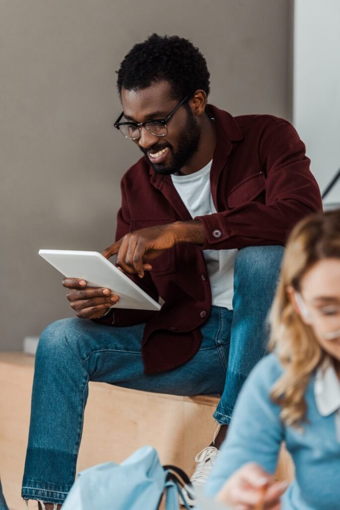 Smiling African American student using a digital tablet